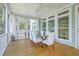 Screened porch features a glass-top dining table and comfortable seating at 1504 Rivertowne Country Club Dr, Mount Pleasant, SC 29466