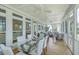 Spacious screened porch with dining area and seating overlooking backyard at 1504 Rivertowne Country Club Dr, Mount Pleasant, SC 29466