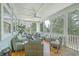 Large screened porch with comfortable seating and wooded views at 1504 Rivertowne Country Club Dr, Mount Pleasant, SC 29466