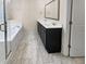 Bathroom with double vanity, soaking tub, and glass shower at 1813 Towne St, Johns Island, SC 29455