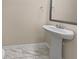 Small bathroom with pedestal sink and marble-look flooring at 1813 Towne St, Johns Island, SC 29455