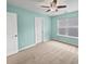 Light teal bedroom with ceiling fan, neutral carpet, and a window with blinds at 1813 Towne St, Johns Island, SC 29455