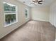 Spacious bedroom with neutral walls and carpet, featuring two windows and a ceiling fan at 1813 Towne St, Johns Island, SC 29455