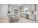 Modern kitchen with island, stainless steel appliances, and light grey cabinets at 189 W Bradford Pointe Dr, Summerville, SC 29486