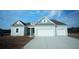 Charming single-story home showcasing a two-car garage and beautifully designed exterior in a desirable neighborhood at 207 Bilge Rd, Ridgeville, SC 29472