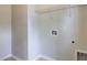 Functional laundry room with overhead shelving and utility hookups at 207 Bilge Rd, Ridgeville, SC 29472
