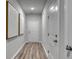 Clean and bright hallway with wood-look floors and stylish artwork at 225 W West Bradford Pointe Dr, Summerville, SC 29483