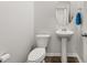 Small bathroom with pedestal sink, toilet, and oval mirror at 241 Swamp Creek Ln, Moncks Corner, SC 29461