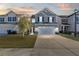 Two-story house with gray siding, white garage door, and landscaped lawn at 241 Swamp Creek Ln, Moncks Corner, SC 29461