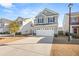 Two-story house with gray siding, white garage doors, and a landscaped yard at 241 Swamp Creek Ln, Moncks Corner, SC 29461