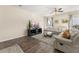 Living room with hardwood floors, sectional sofa, and a large TV at 241 Swamp Creek Ln, Moncks Corner, SC 29461
