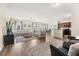 Spacious living room with hardwood floors, sectional sofa, and large windows at 241 Swamp Creek Ln, Moncks Corner, SC 29461