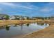 Community pond view with homes and landscaping at 310 Bloomington Way, Summerville, SC 29486