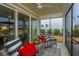 Cozy screened porch with wicker furniture and red accent pillows at 310 Bloomington Way, Summerville, SC 29486