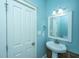 Simple bathroom with pedestal sink, mirror and white vanity at 490 Cummings Chapel Rd, Ridgeville, SC 29472