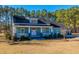 A light blue house with a wraparound porch and manicured lawn at 490 Cummings Chapel Rd, Ridgeville, SC 29472