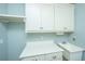 Laundry room features white cabinets, a utility sink, and ample counter space at 490 Cummings Chapel Rd, Ridgeville, SC 29472