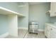 Bright laundry room with built-in cabinets, shelving, and a large ice maker at 490 Cummings Chapel Rd, Ridgeville, SC 29472