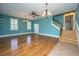 Living room with hardwood floors, staircase, and ceiling fan at 490 Cummings Chapel Rd, Ridgeville, SC 29472