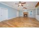 Spacious living room with hardwood floors and a brick fireplace at 490 Cummings Chapel Rd, Ridgeville, SC 29472