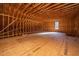 Large unfinished bonus room with window and wood framing at 490 Cummings Chapel Rd, Ridgeville, SC 29472