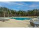 Resort-style community pool with ample seating and a backdrop of lush greenery at 507 N Commodore Way, Summerville, SC 29483