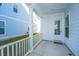 Covered back porch with white railing and door access at 507 N Commodore Way, Summerville, SC 29483