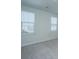 Spacious bedroom with two windows and grey carpet at 507 N Commodore Way, Summerville, SC 29483