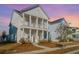 Two-story white house with front porch, landscaping, and sidewalk at 507 N Commodore Way, Summerville, SC 29483