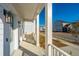 Bright front porch with white columns and railing, and street view at 507 N Commodore Way, Summerville, SC 29483