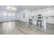 Modern kitchen with white cabinets, island, and stainless steel appliances at 507 N Commodore Way, Summerville, SC 29483
