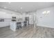 Open concept kitchen with island, stainless steel appliances, and white cabinets at 507 N Commodore Way, Summerville, SC 29483