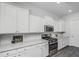 Modern kitchen with white cabinets and stainless steel appliances at 507 N Commodore Way, Summerville, SC 29483