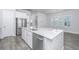Modern kitchen with island, sink, dishwasher, and white cabinets at 507 N Commodore Way, Summerville, SC 29483