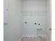 Well-lit laundry room with tile floor and shelving at 723 Blue Iris Way, Summerville, SC 29486