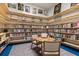 Cozy library nook with shelves full of books, artwork, and a table with chairs for reading at 723 Blue Iris Way, Summerville, SC 29486