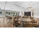 Large meeting room with wood floors, elegant lighting, and an exit leading to outdoor amenities at 723 Blue Iris Way, Summerville, SC 29486