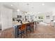 Modern kitchen with granite island, stainless steel appliances, and hardwood floors at 1015 Marsh Harrier Dr # Cc3-3-2, Ravenel, SC 29470