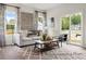 Living Room with light gray sofa, sliding glass door, and hardwood floors at 1015 Marsh Harrier Dr # Cc3-3-2, Ravenel, SC 29470