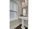 Small bathroom with pedestal sink, mirror, and window with blinds at 1040 Hills Plantation Dr, Charleston, SC 29412