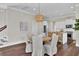 Open concept dining room with a round table and chairs, hardwood floors, and access to the kitchen at 1040 Hills Plantation Dr, Charleston, SC 29412