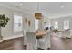 Open dining room with a round table, hardwood floors, and views into the living room and kitchen at 1040 Hills Plantation Dr, Charleston, SC 29412