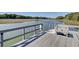 Waterfront home features a private dock with bench seating, offering stunning views of the serene marsh and waterway at 1040 Hills Plantation Dr, Charleston, SC 29412