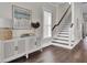 Bright entryway with hardwood floors, storage cabinet, and staircase at 1040 Hills Plantation Dr, Charleston, SC 29412