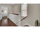 Upstairs hallway with hardwood floors and a white railing staircase at 1040 Hills Plantation Dr, Charleston, SC 29412