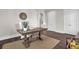 Bright home office features a wooden desk and chair, hardwood floors, and natural light at 1040 Hills Plantation Dr, Charleston, SC 29412