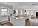 Open concept kitchen with island, white cabinets, and stainless steel appliances at 1040 Hills Plantation Dr, Charleston, SC 29412