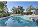 Community pool showcasing several lounge chairs and umbrellas in a beautiful outdoor setting at 1040 Hills Plantation Dr, Charleston, SC 29412