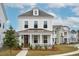 Two-story home with a front porch and landscaped yard at 1245 Crooked Oak Rd, Charleston, SC 29492