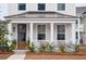 Two-story home with a charming front porch and metal roof at 1245 Crooked Oak Rd, Charleston, SC 29492